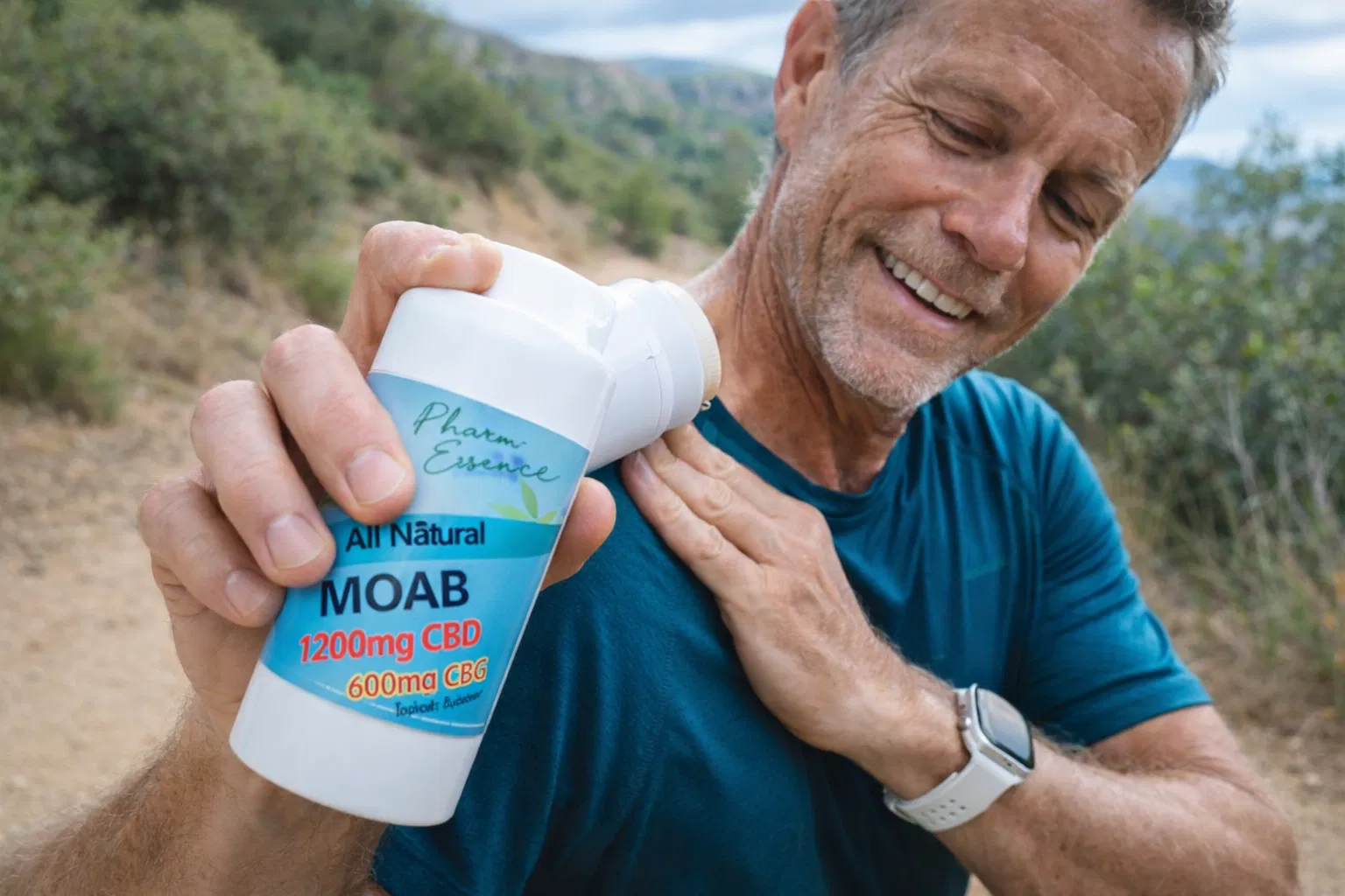 Man applying MOAB stick to his shoulder on an outdoor trail